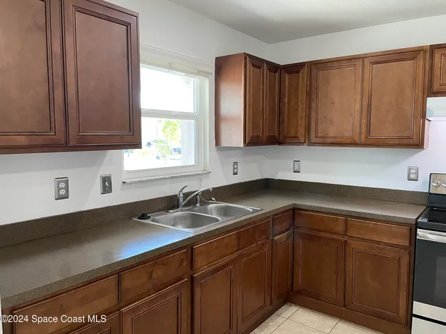 a kitchen with a sink cabinets and utility