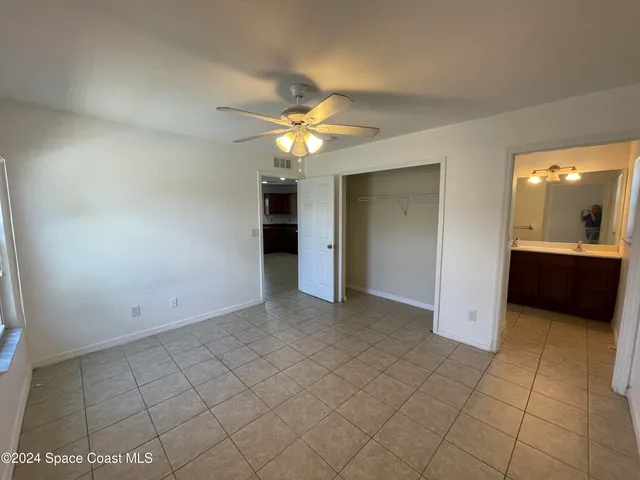 an empty room with a bathroom and a sink