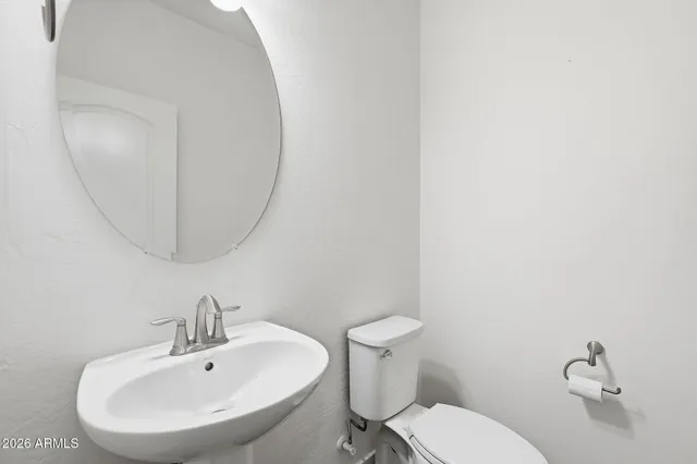 a bathroom with a sink a mirror and a toilet