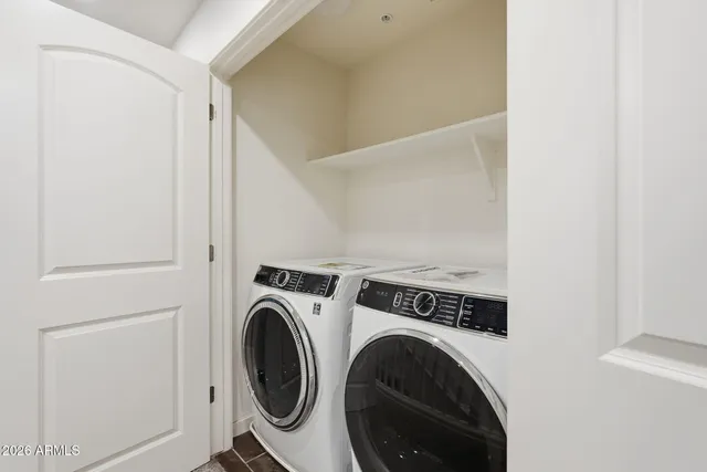 a view of storage and utility room with washer and dryer