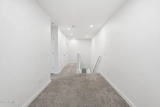 a view of a hallway with stairs