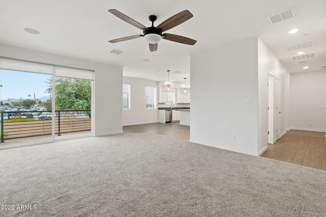 a view of empty room with wooden floor and windows