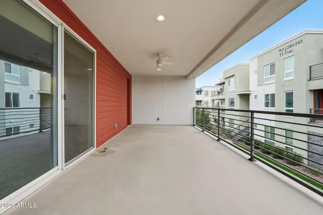 a view of an empty room with a kitchen