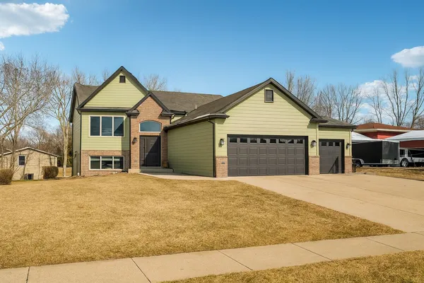 a front view of a house with a yard and garage