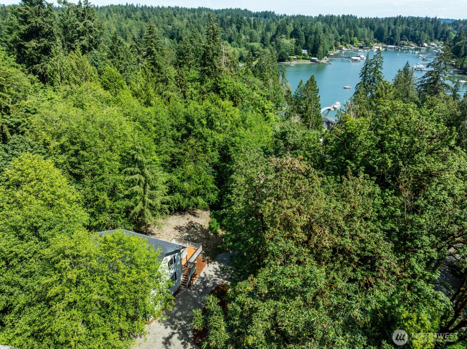 7605 Northeast Hidden Cove Road Bainbridge Island, WA 98110 - Photo 24 of 36 a view of a lake with a house