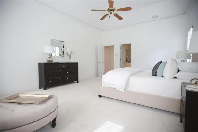 a bedroom with a bed and ceiling fan