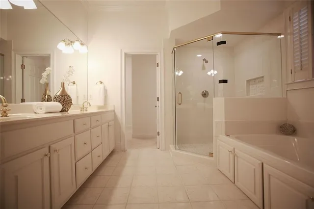 a spacious bathroom with a shower sink double and mirror