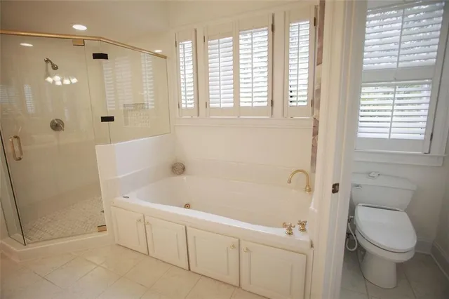 a white bath tub sitting next to a toilet