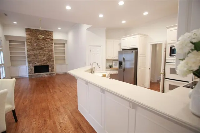 a large kitchen with kitchen island granite countertop a large counter top stainless steel appliances and cabinets