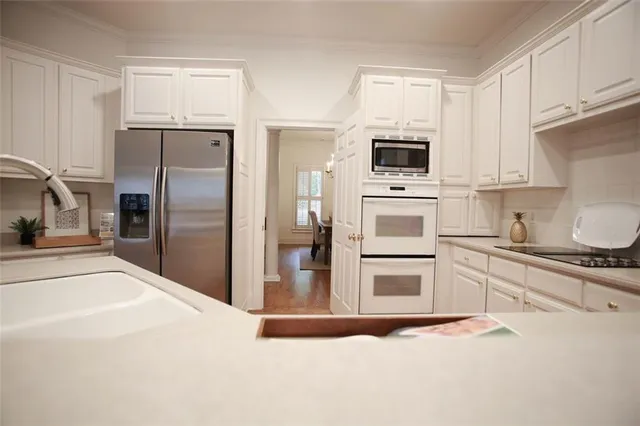 a kitchen with a refrigerator stove and microwave