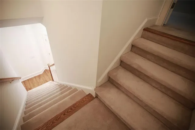a bedroom with a bed and a potted plant