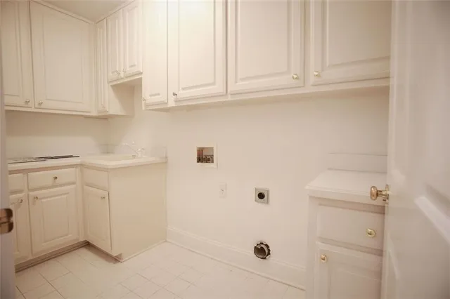 a bathroom with white cabinets