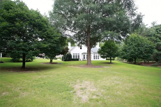 a view of a trees in front of a house with trees