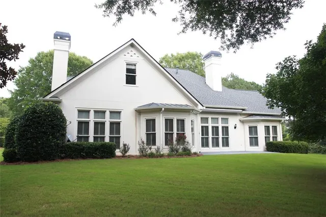 a front view of a house with a garden