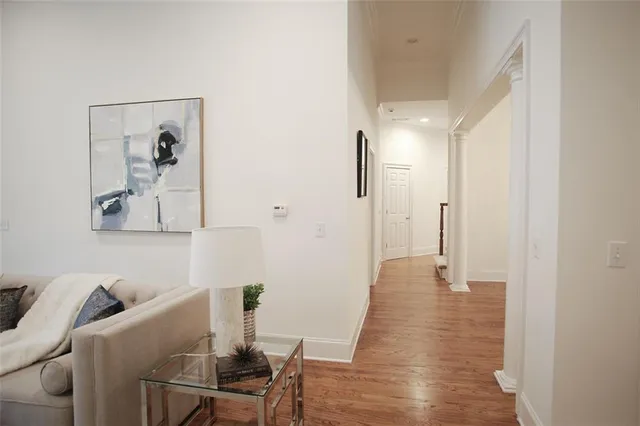 a living room with furniture and wooden floor