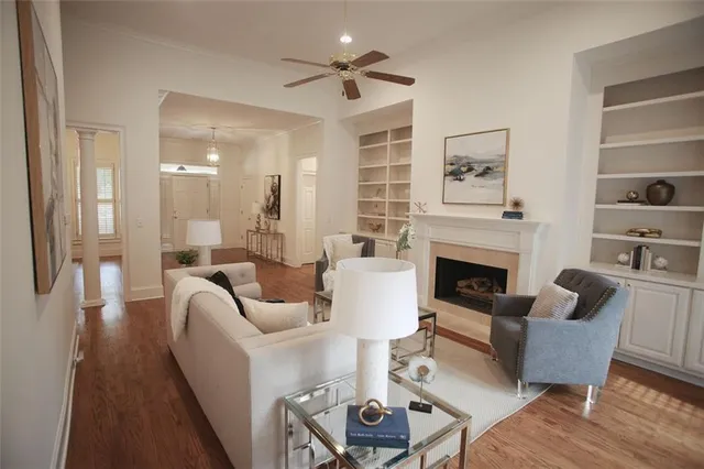a living room with furniture a fireplace and a chandelier