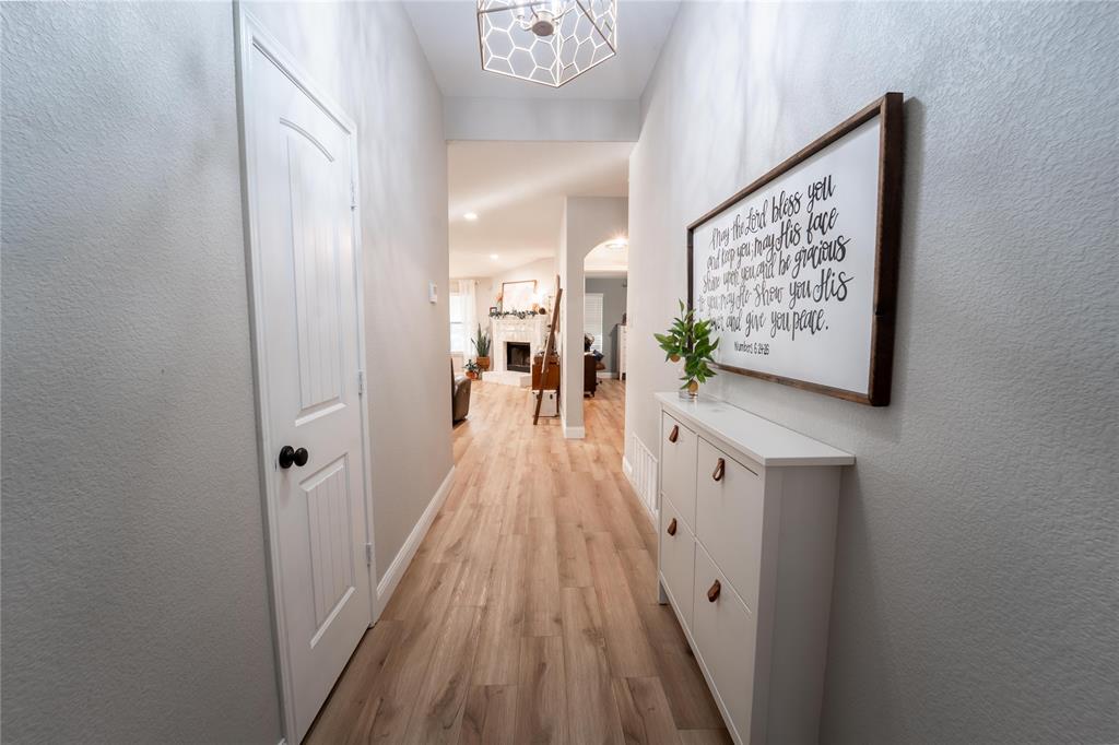 5521 Wisdom Court Waco, TX 76708 - Photo 4 of 28 Hallway featuring wood-finish flooring, light grey walls, and a recessed ceiling light fixture