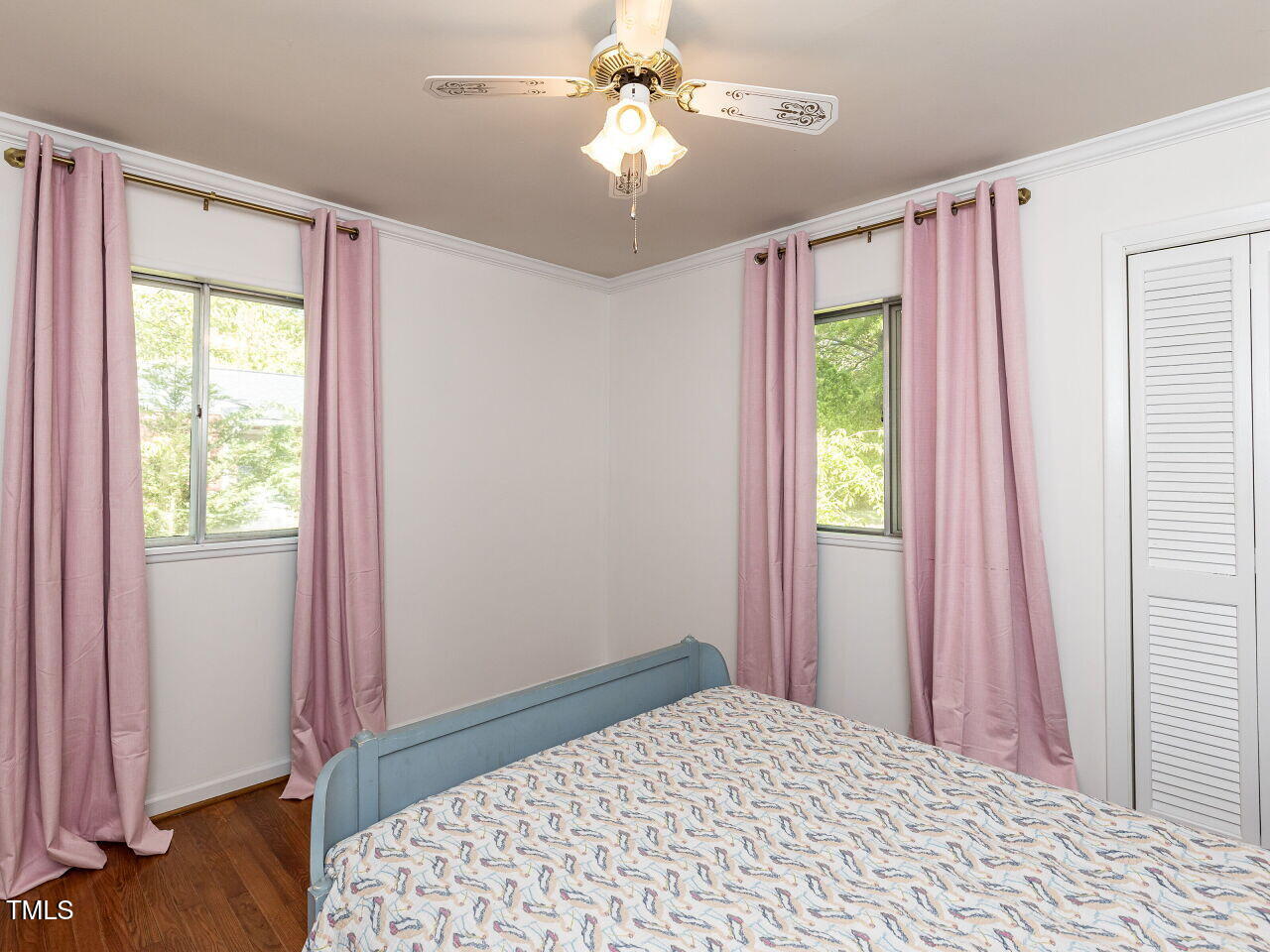 1317 Kelly Road Garner, NC 27529 - Photo 19 of 31 a bedroom with a bed and a chandelier