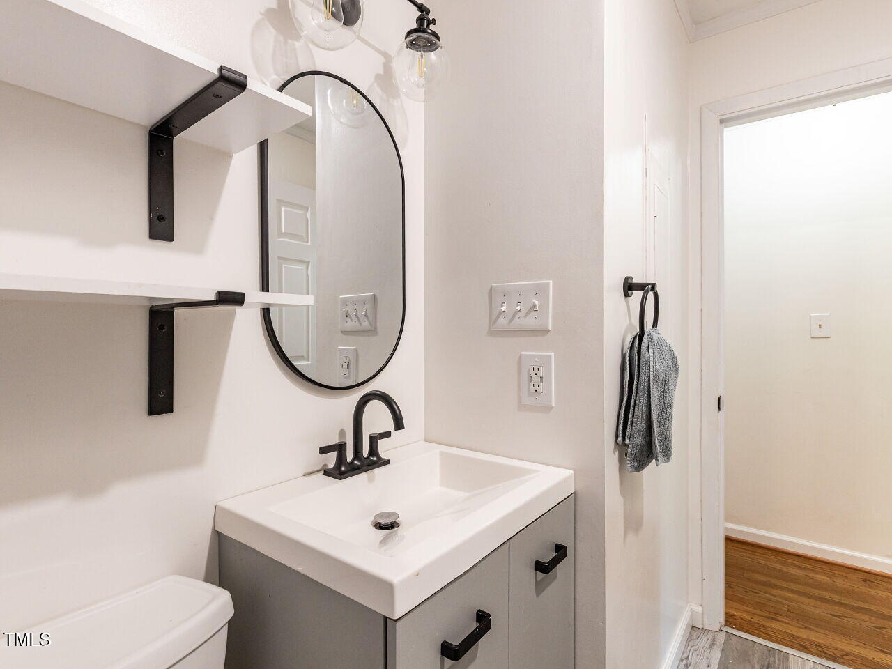 1317 Kelly Road Garner, NC 27529 - Photo 27 of 31 a bathroom with a sink a toilet and a mirror