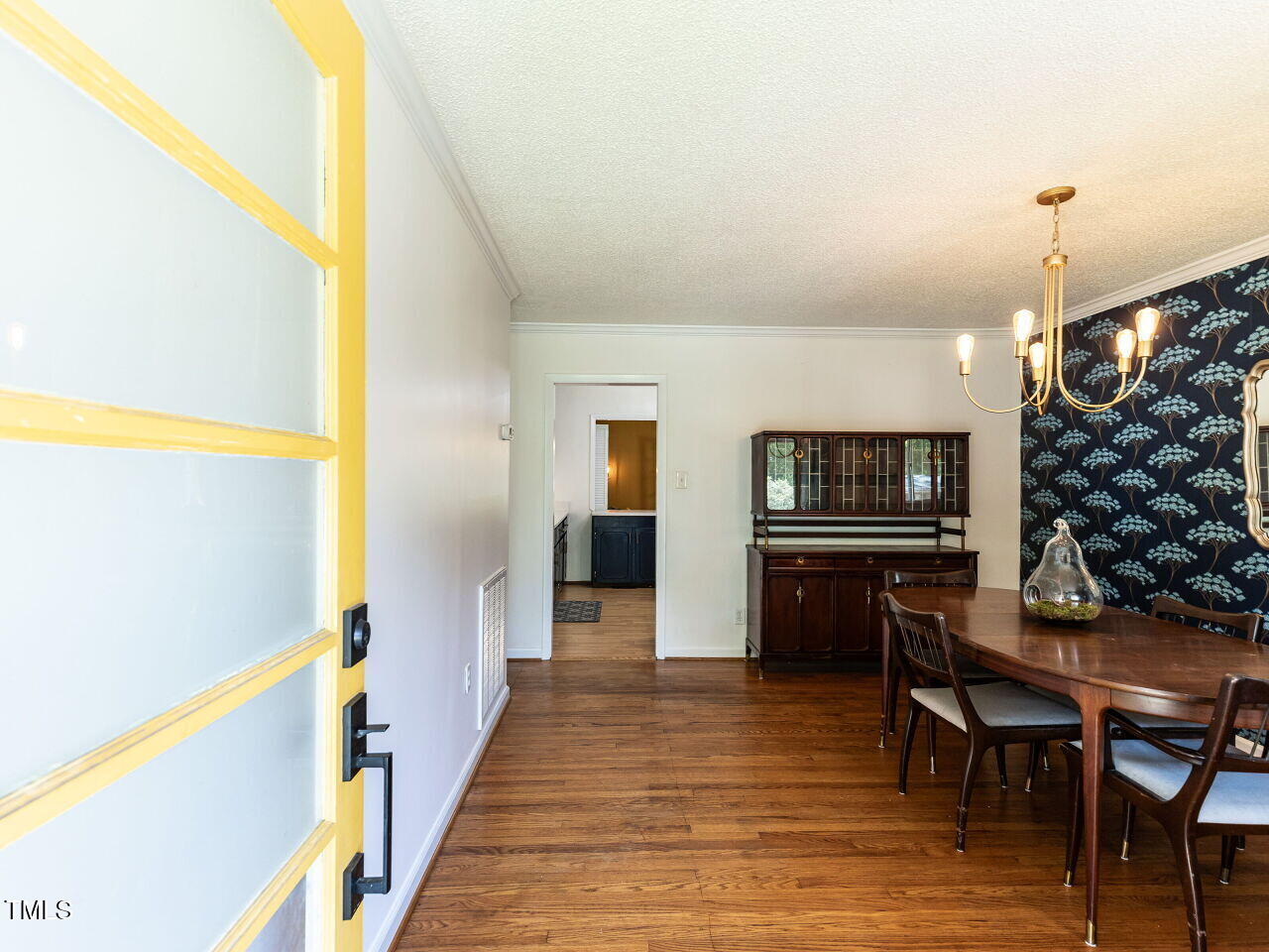 1317 Kelly Road Garner, NC 27529 - Photo 4 of 31 a view of a hallway to dining room with furniture and wooden floor