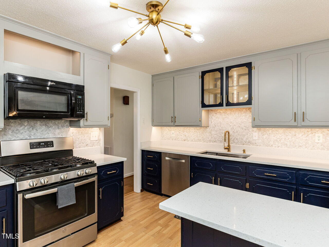 1317 Kelly Road Garner, NC 27529 - Photo 8 of 31 a kitchen with stainless steel appliances a sink and a stove