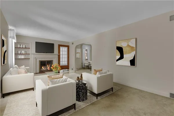 a living room with furniture a fireplace and a flat screen tv