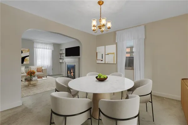 a view of a dining room with furniture and a chandelier
