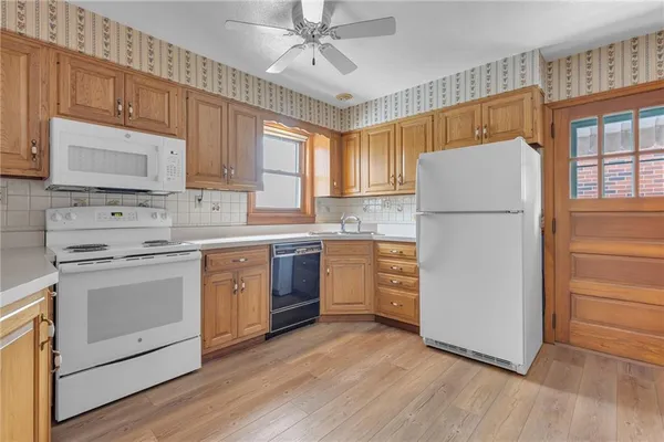a kitchen with a white cabinets and white appliances