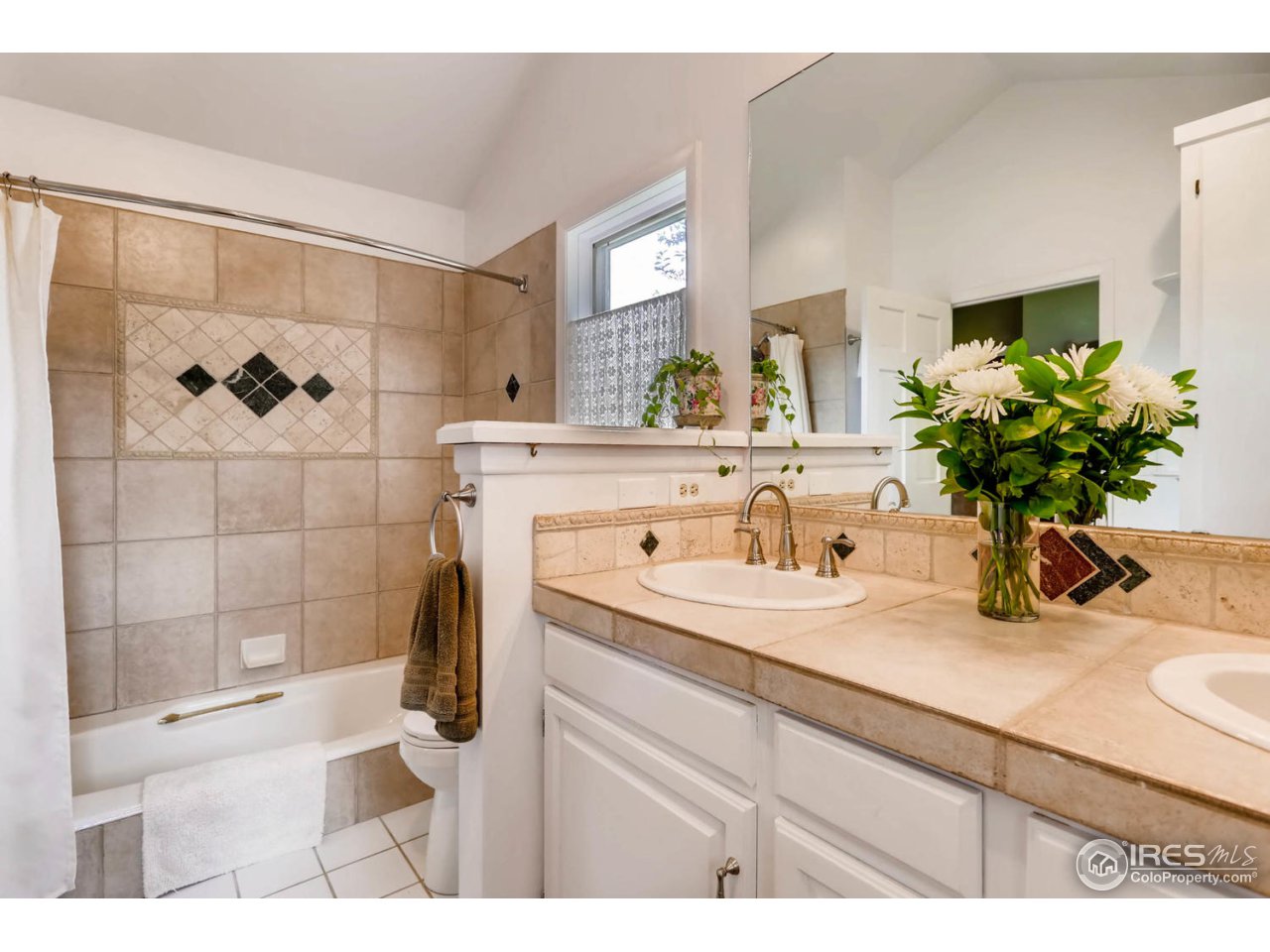9760 Isabelle Road Lafayette, CO 80026 - Photo 13 of 40 a bathroom with a sink a vanity and a mirror