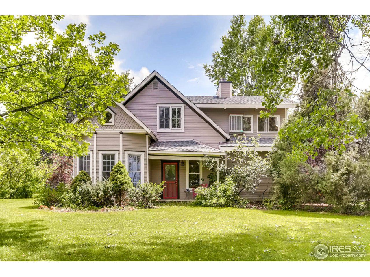 9760 Isabelle Road Lafayette, CO 80026 - Photo 5 of 40 a front view of a house with a yard