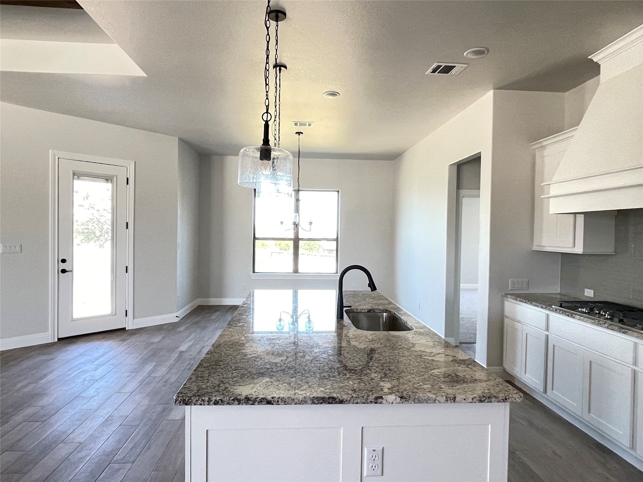 104 Creek Point Drive Georgetown, TX 78628 - Photo 14 of 18 a kitchen with sink a refrigerator and wooden floor
