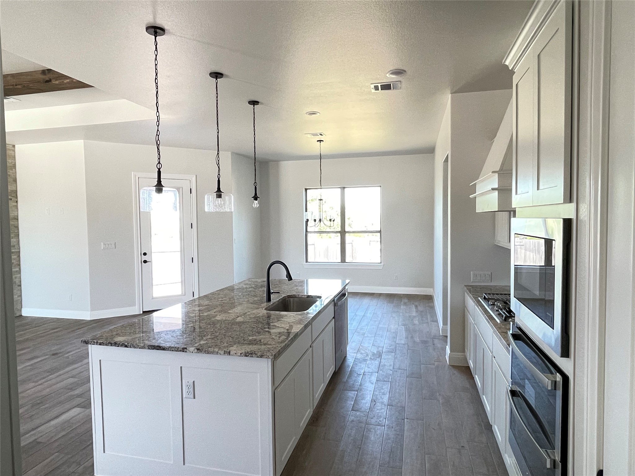 104 Creek Point Drive Georgetown, TX 78628 - Photo 6 of 18 a kitchen with a sink a counter top space stainless steel appliances and cabinets