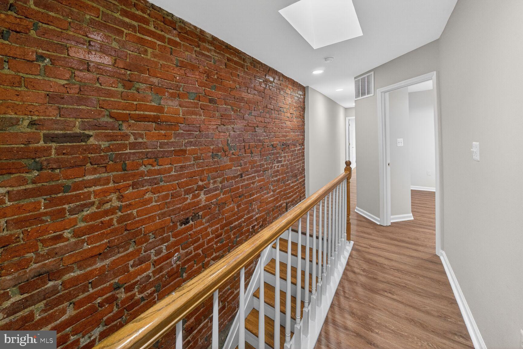 46 Florida Avenue Northwest Washington, DC 20001 - Photo 14 of 40 Charming hallway with exposed brick accents.