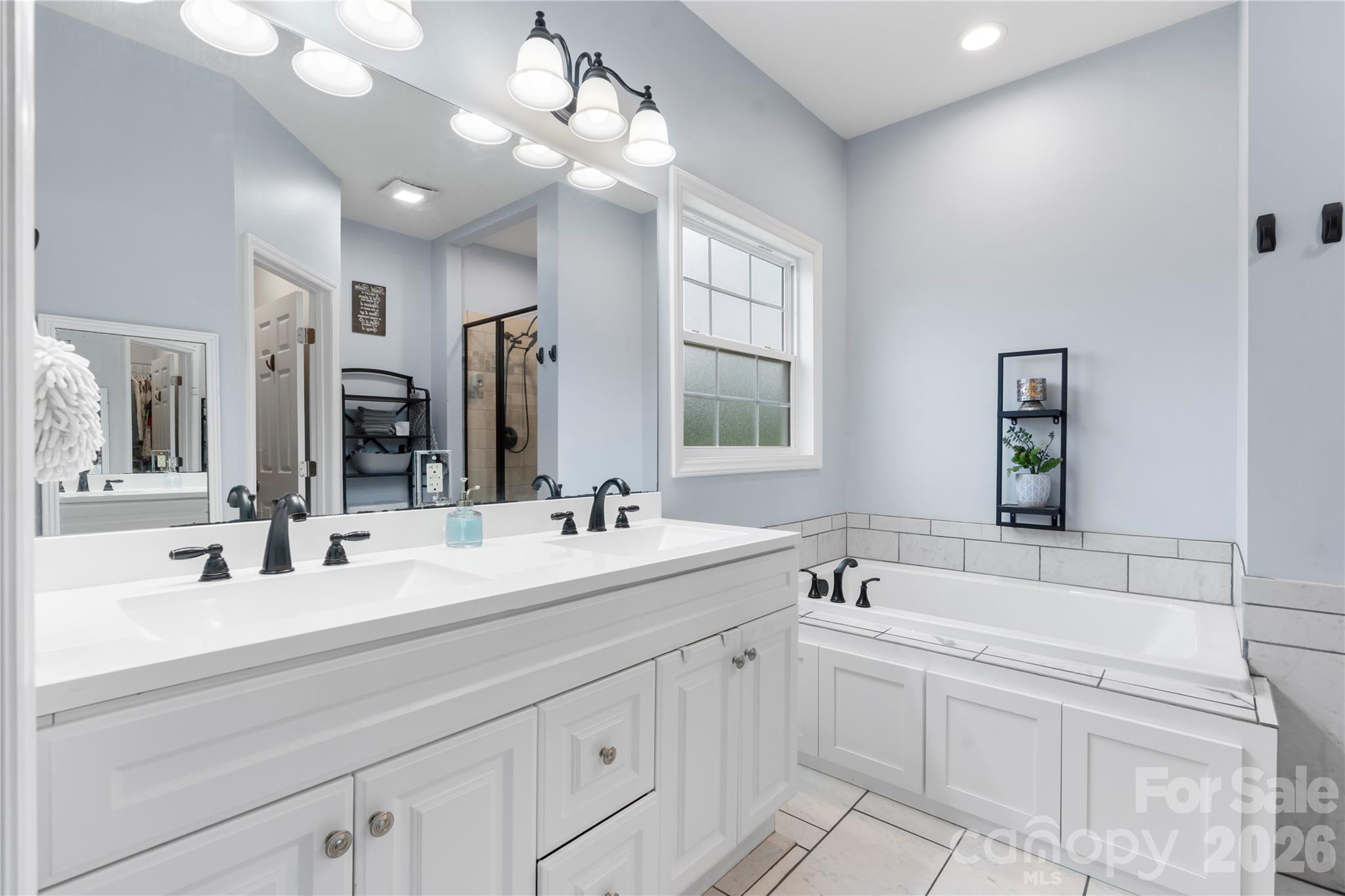111 Pinewood Road Granite Falls, NC 28630 - Photo 15 of 33 a bathroom with double vanity sink a mirror and a bathtub
