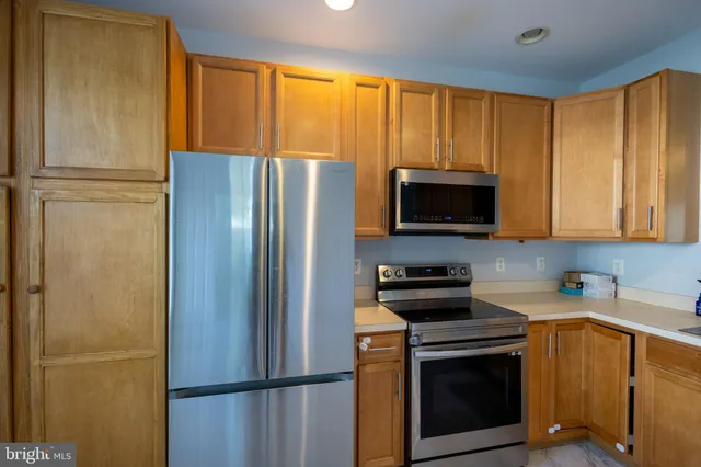 a kitchen with a refrigerator stove and microwave