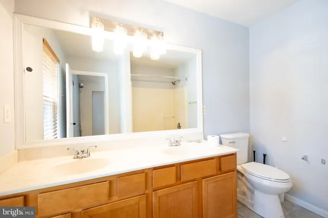 a bathroom with a bathtub sink vanity mirror and toilet