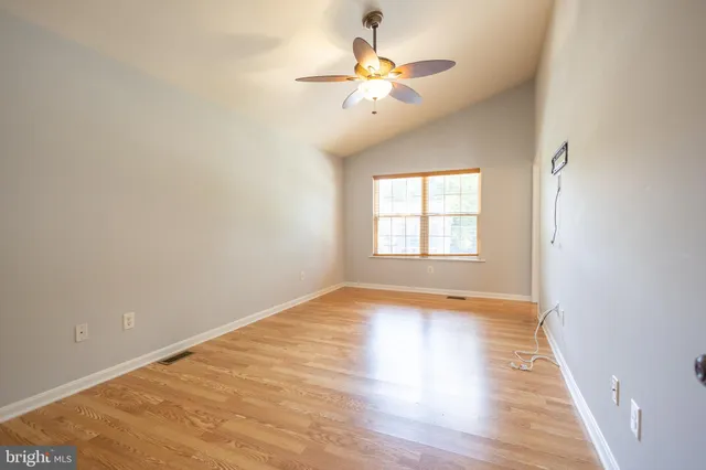wooden floor in an empty room with a window