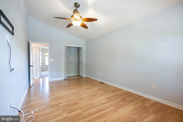 a view of an empty room with wooden floor
