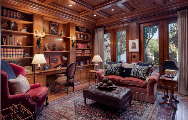 a living room with furniture a bookshelf and a large window