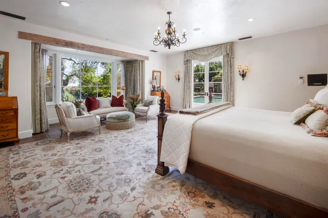 a bed room with a bed and a chandelier