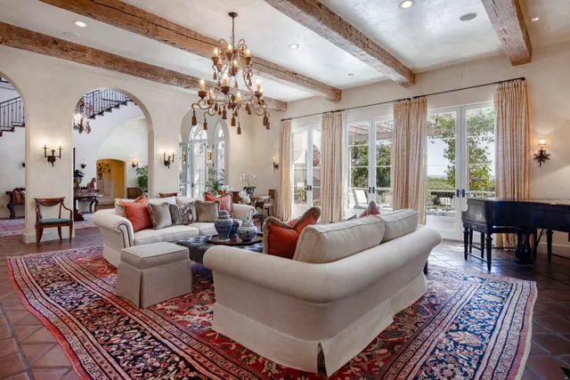a living room with furniture and a chandelier