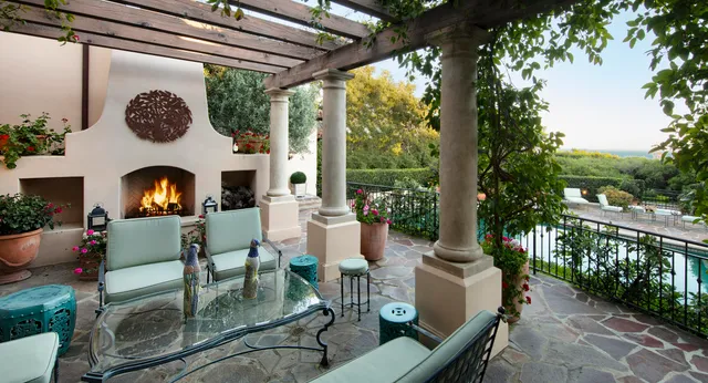 a view of a patio with couches chairs and a fire pit