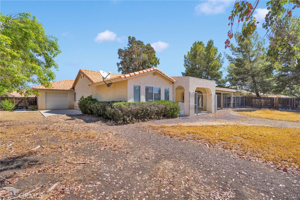 20403 Ochoa Road Apple Valley, CA 92307 - Photo 5 of 48 a front view of a house with a yard