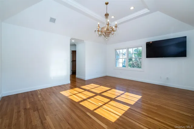 a view of a room with wooden floor and windows
