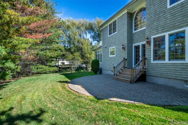 a view of a house with backyard and sitting area