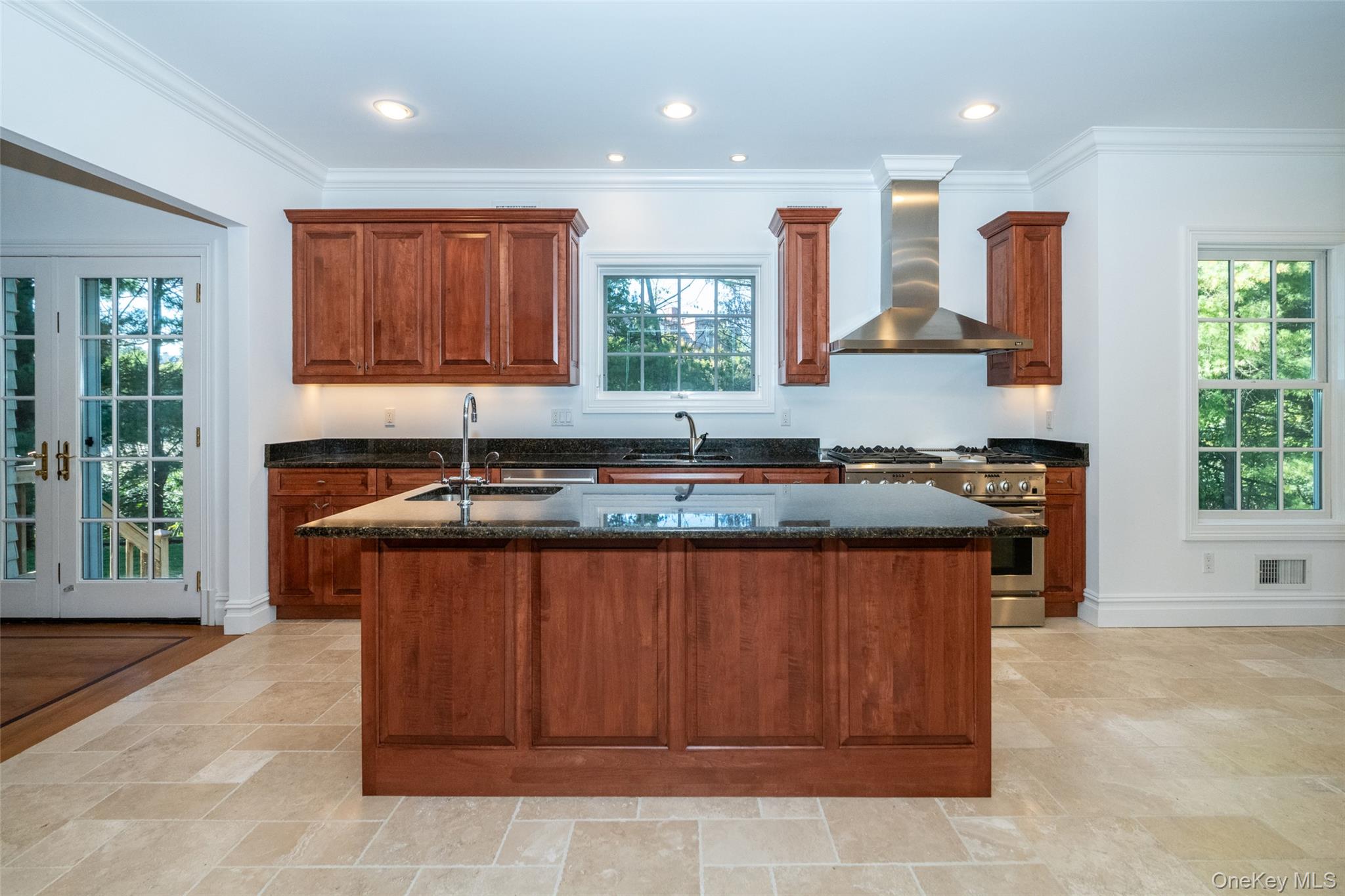 1 Mill Pond Lane New Rochelle, NY 10805 - Photo 5 of 38 a kitchen with granite countertop a stove a sink and a microwave