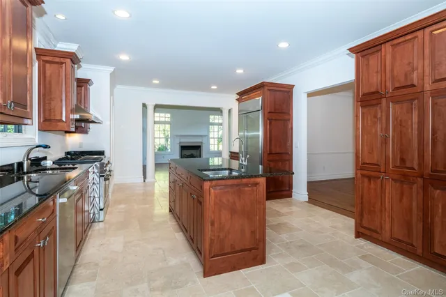 a kitchen with stainless steel appliances granite countertop wooden cabinets a sink and a stove