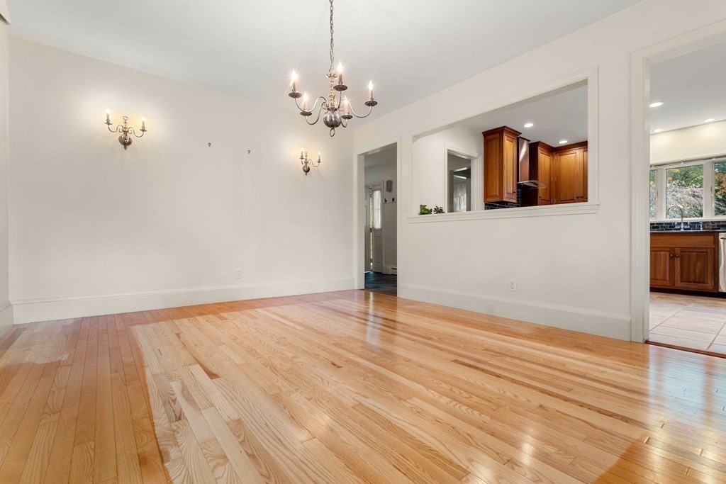 22 Arrowhead Road Marblehead, MA 01945 - Photo 15 of 34 a view of an empty room with wooden floor and a kitchen