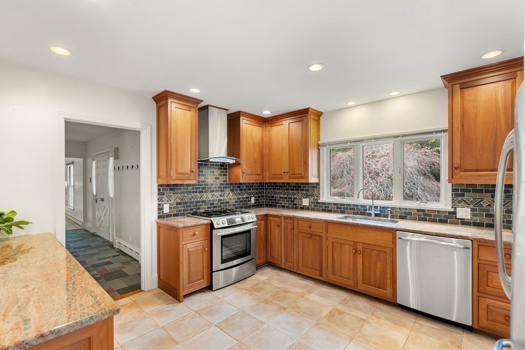 22 Arrowhead Road Marblehead, MA 01945 - Photo 9 of 34 a large kitchen with stainless steel appliances granite countertop a stove a sink and a refrigerator