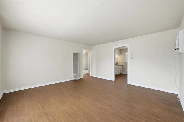 a view of an empty room and wooden floor